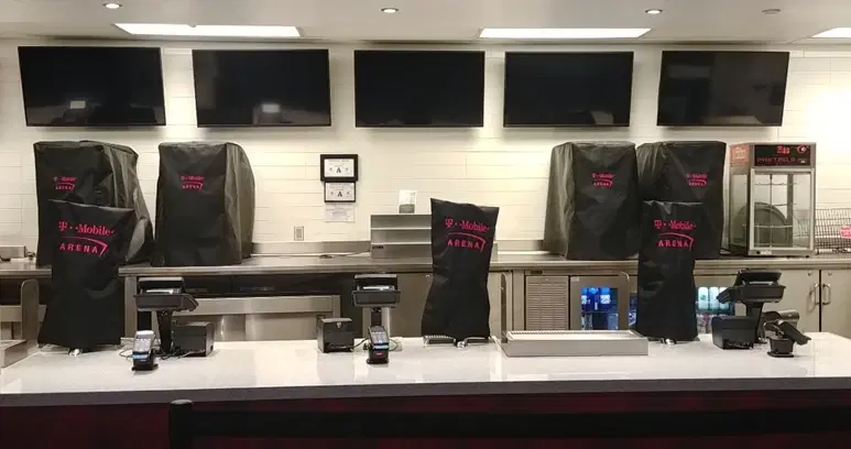Elegant hotel ballroom with white chair covers and floor-length tablecloths
